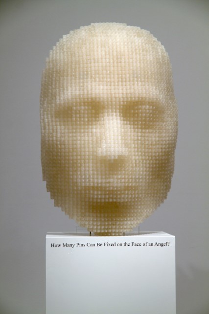 How many pins could be fixed on the face of an angel?